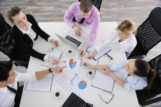 Group of young business people sitting in board room during meeting and discussing with paperwork Identify your top ten competitors